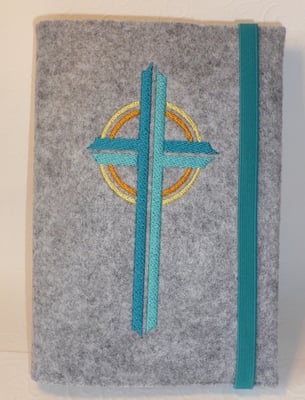 Stickmotiv Kreuz in türkis-gelb mit Gummi in petrol auf Filz in hellgrau-meliert