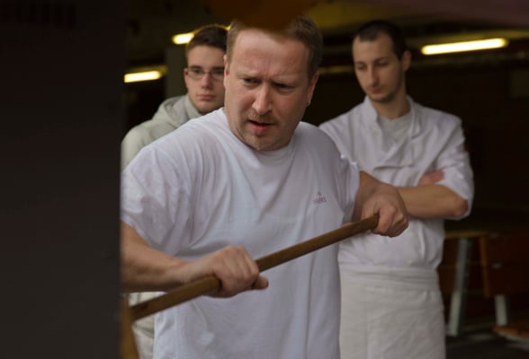 Schulbäckerei, Matthias Zinn, im Hintergrund Lehrlinge aus JPRS-Partnerschule in Chaumont