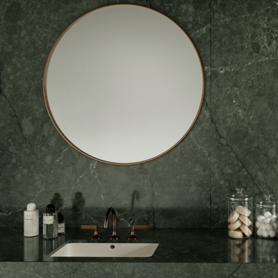 Bathroom wall covered in green Silestone Jardine Emerald quartz