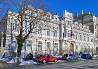 Embassy of France in Riga in winter with red, white and blue cars parked in front