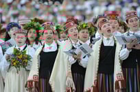 Group of girls in folk costumes singing in Latvian Song Festival