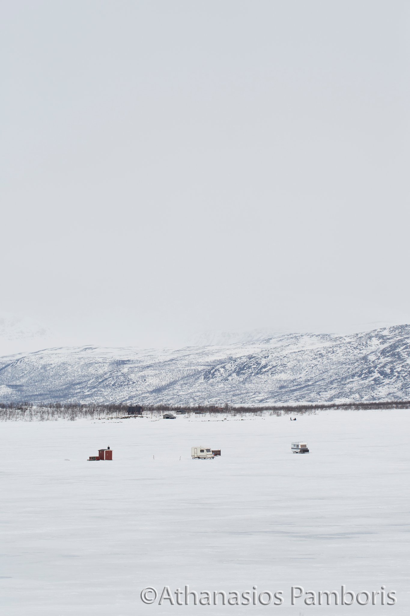 Ice fishing on Lake Tornetrask, Abisko, Sweden