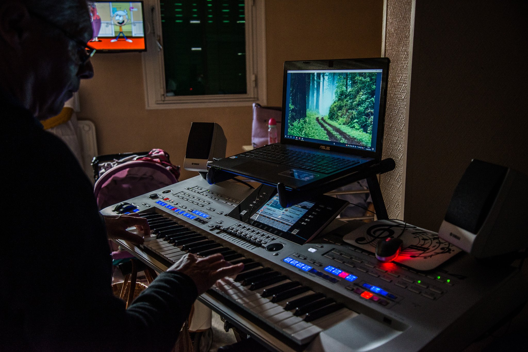 Intervention dans une chambre où la famille de la patiente est présente, ses petits enfants regardent des dessins animés