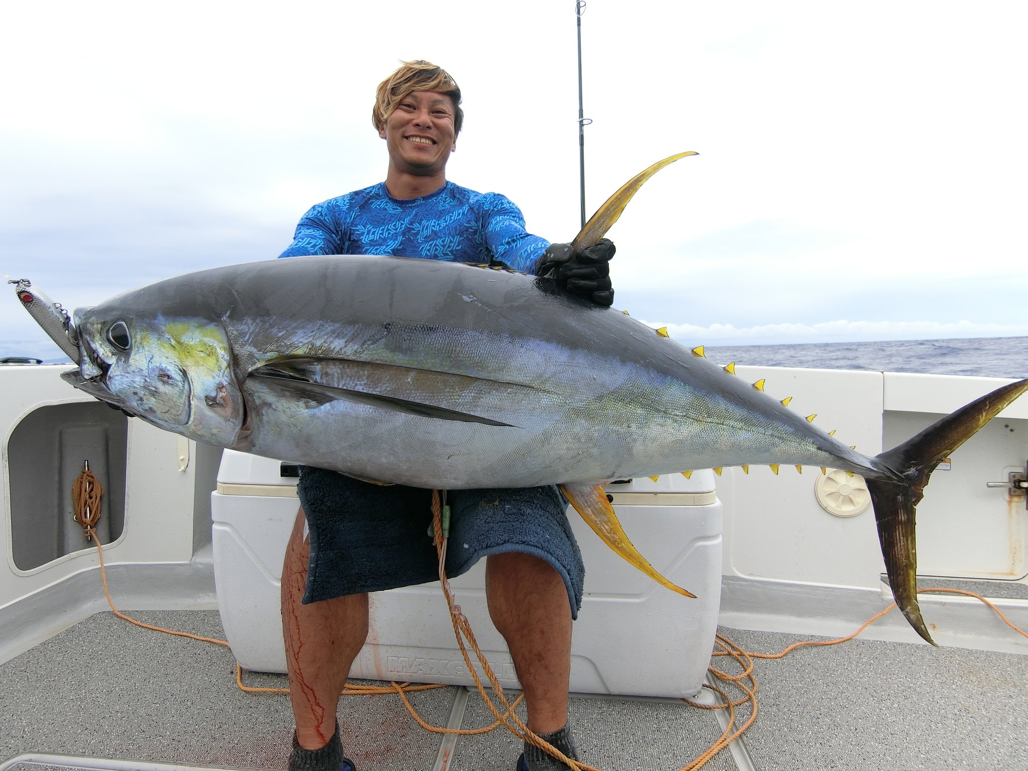 大型マグロを物持ちで掲げたファイト後の記念写真