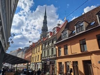 Row of colourful houses and St. Peter's Church Tower in Old Riga