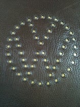 VW Logo - gestanzt mit hellem Leder unterlegt und mit Zierösen abgesetzt