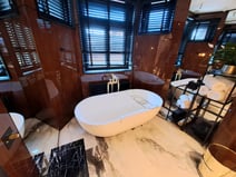 Bathroom with large white bathtub in Hotel A22, Riga