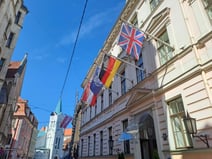 Exterior of Grand Palace Hotel, Riga, with flags of many nations flying above the entrance
