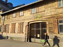 Undown, historic ooden two-story building with a large entry gate in Riga's Pārdaugava district which may have been a tavern in the 19th century