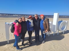 Tourist group on beach in front of Jurmala sign