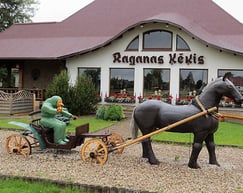 Sculpture of a witch in a horse-drawn cart outside Ragana's ķēkis restaurant in Ragana, Latvia