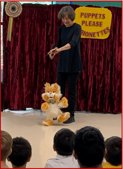 Puppets Please Marionettes puppeteer Terry McManus, performing with a cat marionette in an in-the-round varietyshow