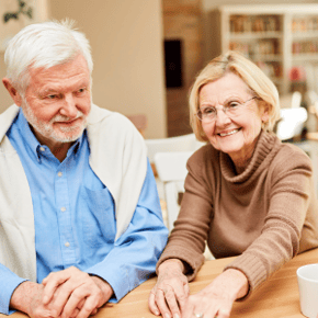 A senior couple sitting at a table