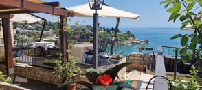 Outdoor terrace seating at À-la-Seaview Restaurant, featuring breathtaking panoramic views of the coastline at Palata Venezia, Ulcinj