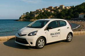 White branded rental car from Palata Venezia parked near the coastline at Mala Plaza in Ulcinj ai generated