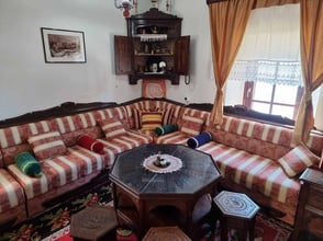Cozy traditional Ulcinj-style living room at Palata Venezia's Bey's Museum featuring rustic furniture, rich textiles, and inviting decor