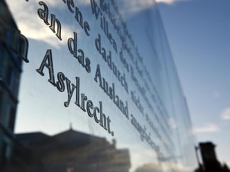 Der Artikel 16 des Grundgesetzes auf einer Plexiglasscheibe am Reichstag. Foto: Jens Kalaene