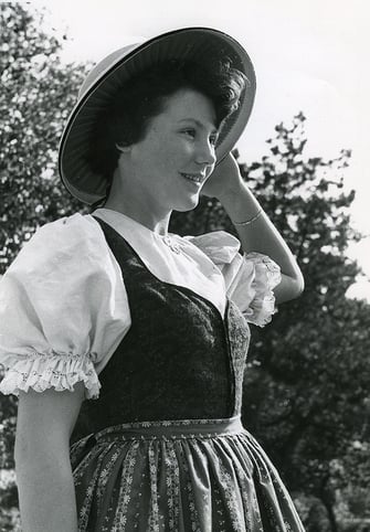 Mädchen im Altoberösterreichischen Leiblkittel mit Trachtenhut. Aufnahme M. Schorsch 1952. (Inv. Nr. LB 01510. Land Oberösterreich. Sammlung Volkskunde und Alltagskultur)
