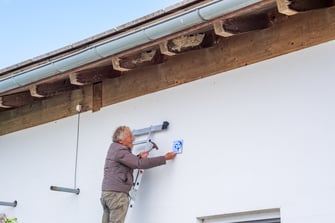 Klaus Janke beim Anbringen der Schwalbenplakette