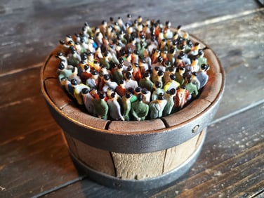 SOLD. Title: 2019. Crowd images from 2019 now seem surreal and antique. Material: 200 dolls in an antique cheese mold. Size: diameter 14 cm.    