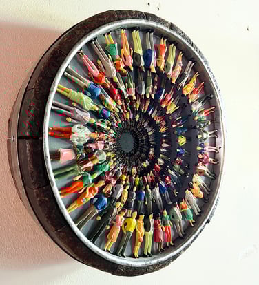 On our way  Plastic figurines in antique cheese mold. Diameter 45 cm. We're on our way but no one seems to know where to.