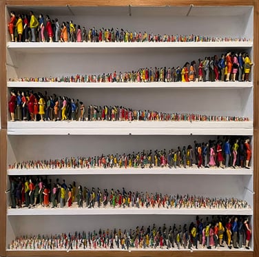 Growing Nowhere  Plastic dolls in vintage wooden drawers, 59 x 59 x 9 cm, 2024     We constantly want to grow, always more. More money, more people, more economic growth, more travel, more discoveries, more more more. 