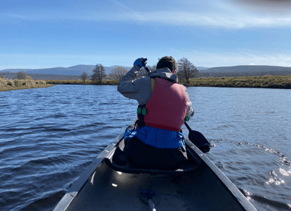 Image of Jamie in the front of the Canoe paddling