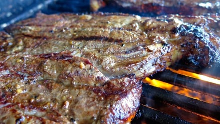 One of our T-bone steaks ready to come off the grill and onto the table. Dry aging, a controlled balance between fat and lean, and intentional breeding makes our beef exceptionally good.