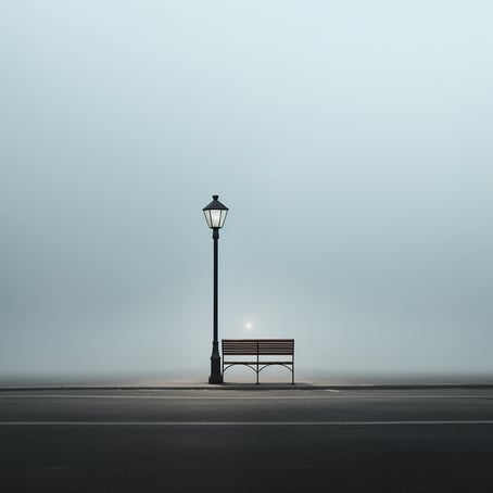 Eine Bank am Rande einer leeren Straße, im Stil des ätherischen Minimalismus, neblige Atmosphäre, realistische Darstellung von Licht, helles Cyan und dunkle Bronze