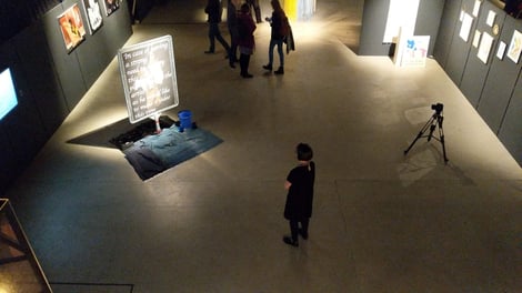 Marianne Iten Thürig "destroying" the poster Salome II of the artist Denys Shantar.