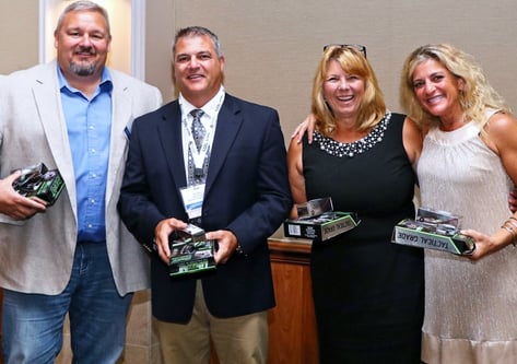 Our Office Manager, Julie Craft (far right), collects her winnings along with her teammates after winning the Team Low Net competition in the golf outing, all made possible by Julie's eagle putt to seal the win!
