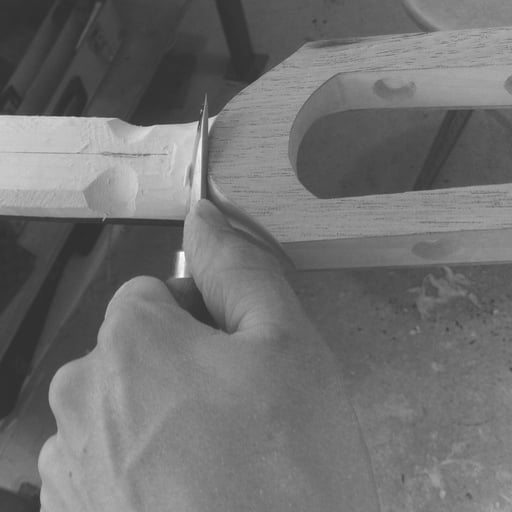 shaping a slotted head Ulrich bassguitar by hand - read the review in bassmagazines