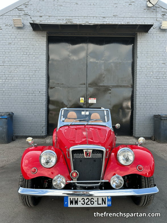The French Spartan in front of the workshop door