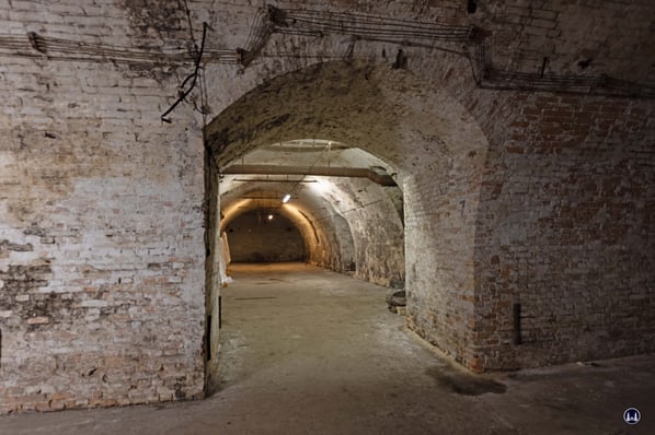 Überall finden sich aufwendig gemauerte Durchgänge, die zu weiteren Gängen führen. Bemerkenswert auch die alten Leitungen, die trapezförmig über den Durchlass geführt wurden.