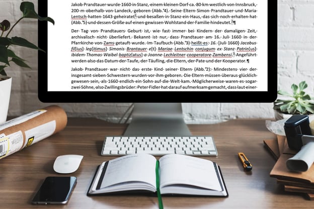 Schreibtisch mit PC und Text mit geschützten Leerzeichen