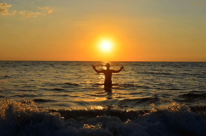 freaky finance, finanzielle Freiheit, Mein Weg in die finanzielle Freiheit, Sonne, untergende Sonne, im Meer untergehende Sonne, Mensch im Meer, Thailand, Sonnenuntergang