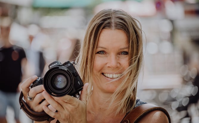 Portraitfoto der Fotografin Uschi Kitschke aus Kreuzau mit ihrer Kamera Nikon Z6 in der Hand.