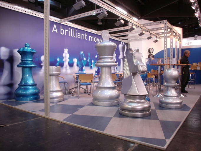 Analog zu Broschüren und Anzeigen präsentierte dieser Messestand als Eyecatcher brillant lackierte Schachfiguren.