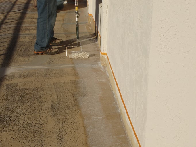 Rolling Ceramic InsulSeal along edge of the vertical wall