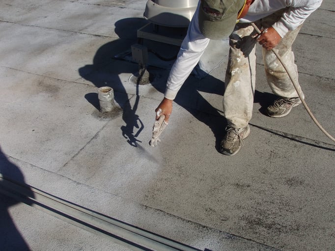 Spraying Ceramic InsulSeal on a Built-Up-Roof (BUR) membrane