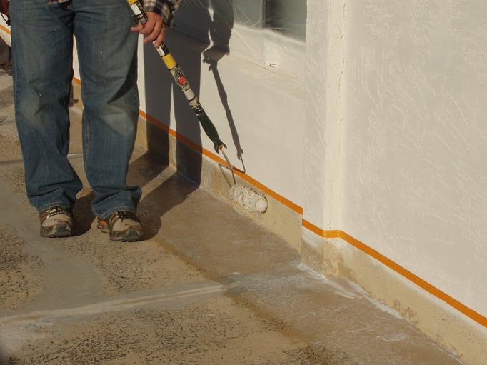 To prevent overspray the contractor chose to roll Ceramic InsulSeal along vertical wall trim