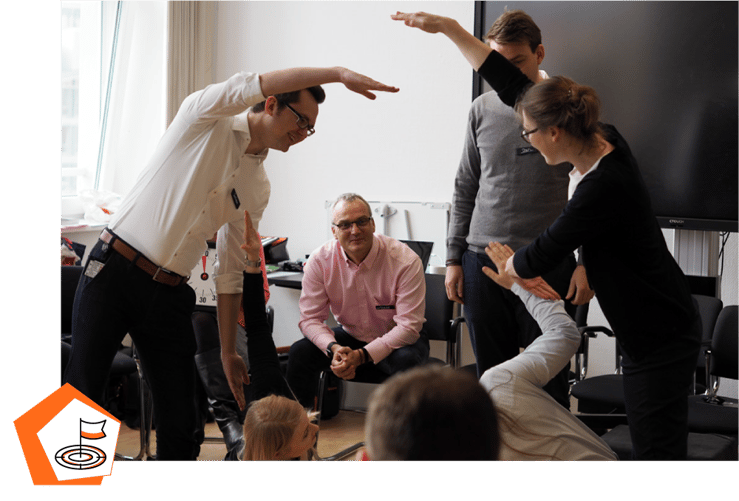 A group of participants pitching their idea to the audience during a Design Thinking Workshop
