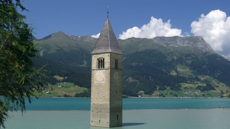 Enjoy Your holidays in South Tyrol at the lake of Resia. The tower or church in the water is the simbol of South Tyrol.