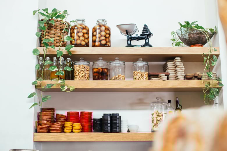 Wooden Shelves with Glass Jars Filled with Various Ingredients in the kitchen butler pantry