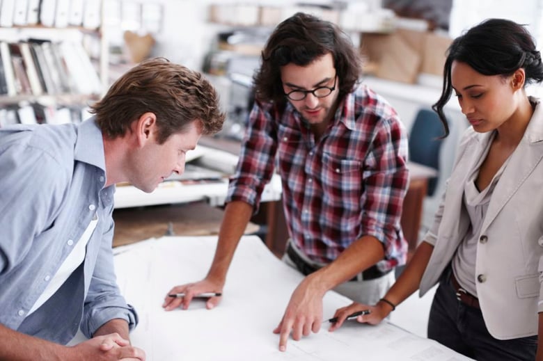A team of architects is collaboratively designing and refining a modern French-style kitchen to meet the client's luxury home aspirations.