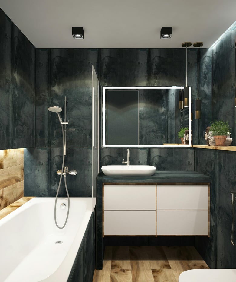 A bathroom combines a bathtub and shower with a glass screen, chrome handheld rail, dark tiles, a wall-hung vanity with a countertop basin, chrome mixers, and an LED mirror.