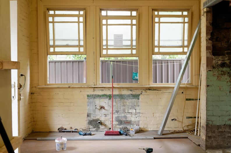 A kitchen stripped down to its bare essentials after demolition, awaiting a fresh transformation as tools and remnants of the old space linger in preparation for the renovation ahead.