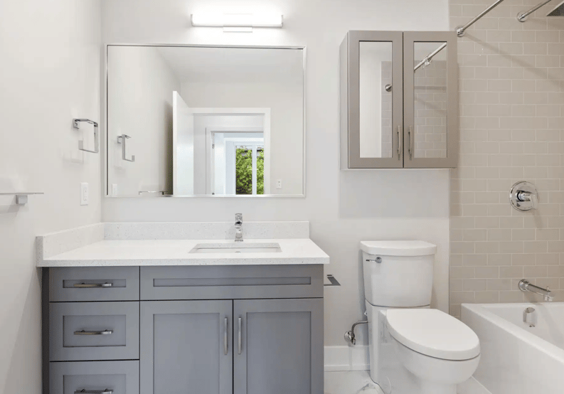 A sleek, contemporary bathroom with light-colored walls, a floating vanity, and an inviting, spacious shower and bath area.