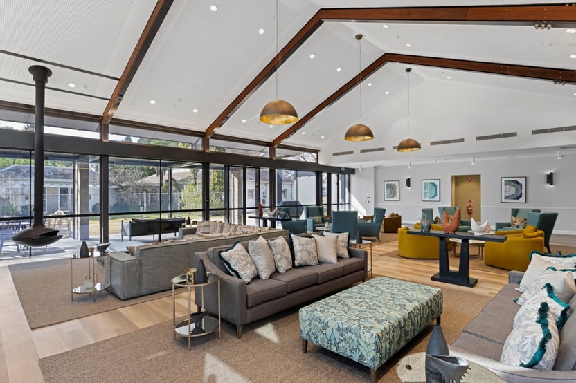 Warm and modern communal lounge in an Over 55s community, designed by Flourish Interior Design