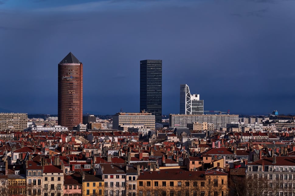 The image shows the photograph of a Cityscape of Lyon at dusk.
